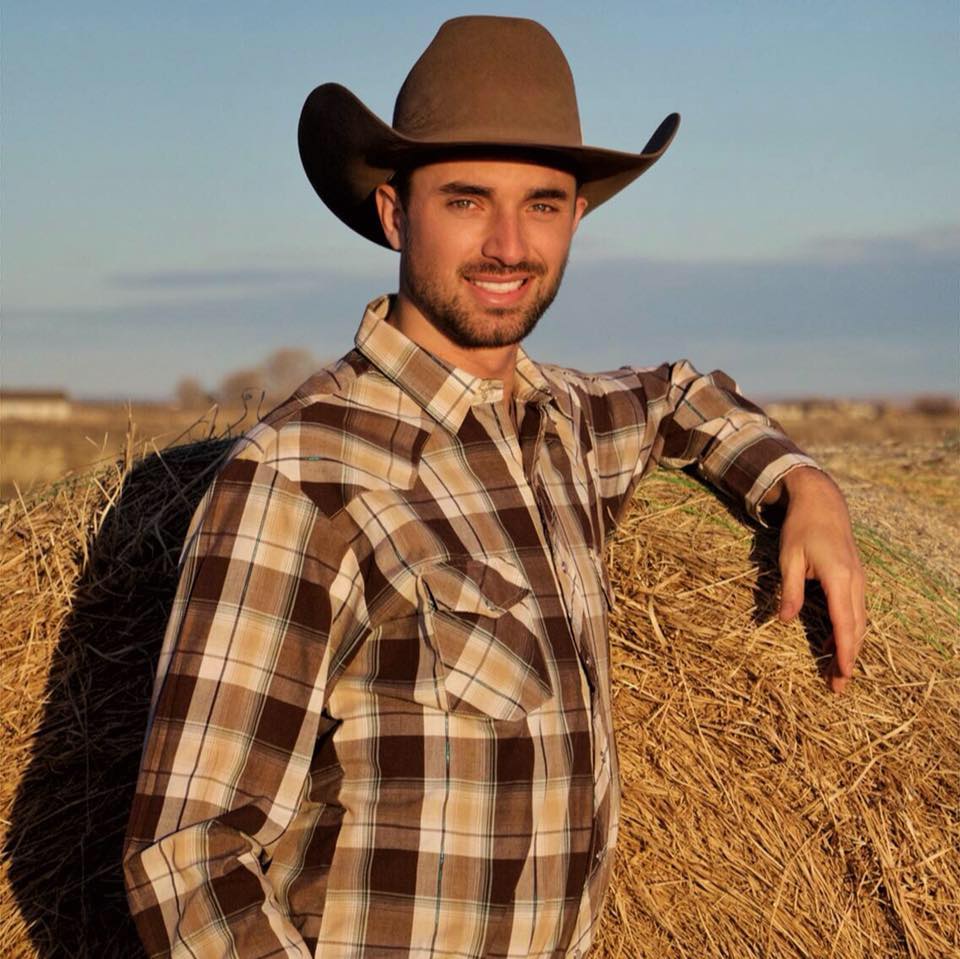 A man wearing flannel and a cowboy hat
